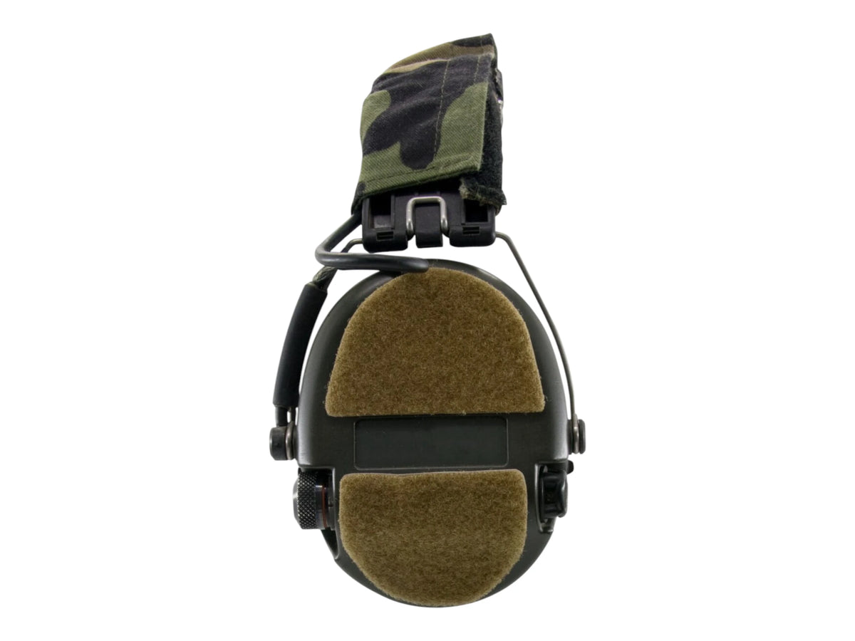 Front view of a headset with tan S14 panels on the ear cup and headband under a camo cover