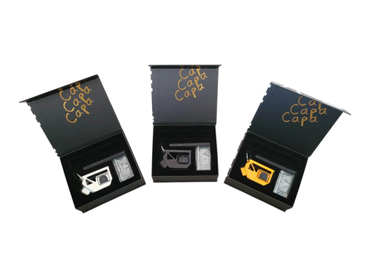 Three Kross Airsoft Design Skelly Hi-Capa adapters in their presentation boxes, silver, black and gold