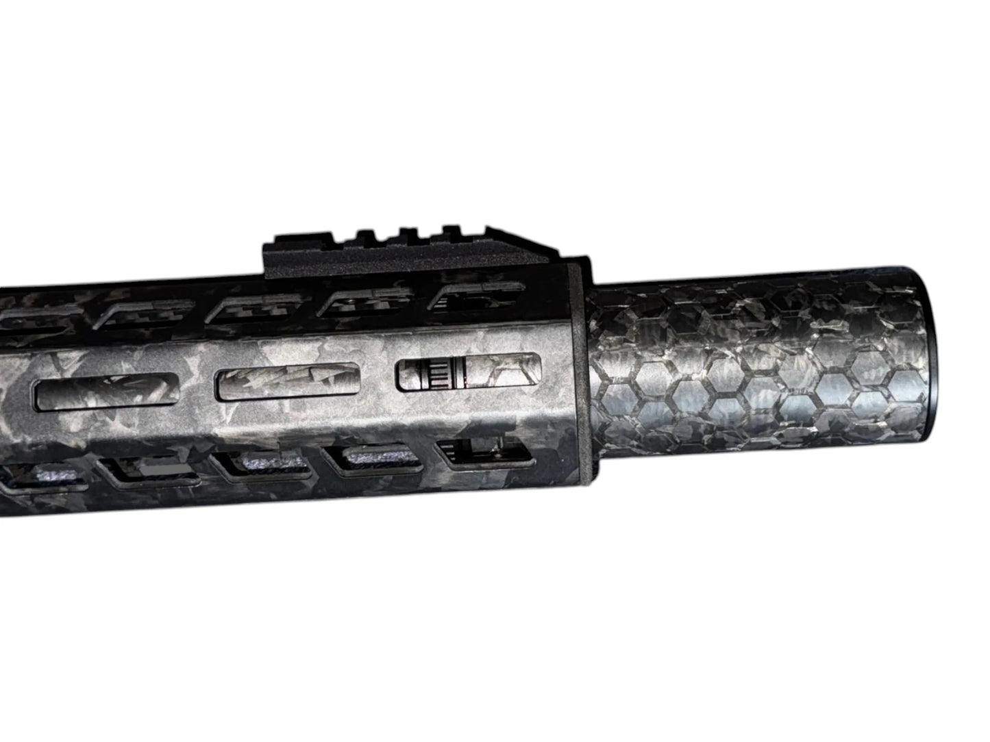 Image 2: Strike Carbon HEX 40 4 inch suppressor showing the laser-engraved hex pattern on the forged carbon body