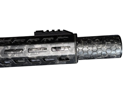 Image 2: Strike Carbon HEX 40 4 inch suppressor showing the laser-engraved hex pattern on the forged carbon body