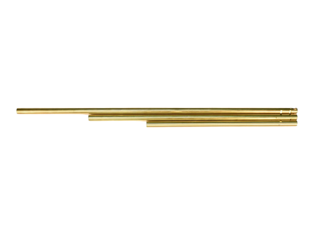 Four Wolverine MTW brass inner barrels of increasing length, laid overlapping on white