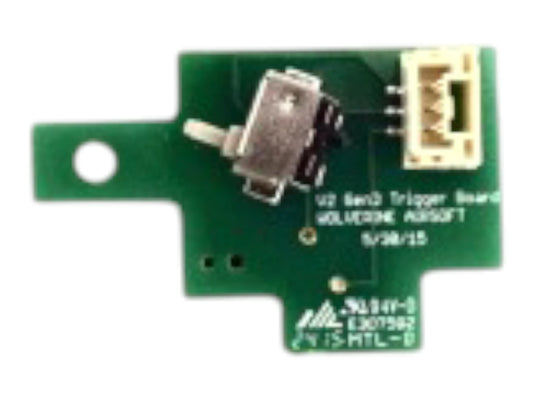 Wolverine V2 Gen 3 trigger board, a green PCB printed with the Wolverine name, a microswitch and a connector